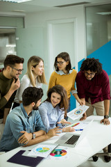 Group of young multiethnic business people working and communicating together in creative office