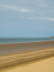 Golden sandy beach . blue sea and sky background with clouds at Instow in North Devon , England