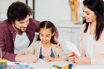 Fototapeta premium happy father near cute daughter with paper plane at home