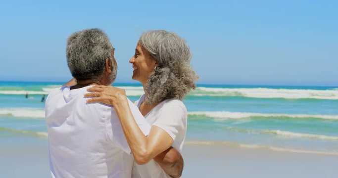Front view of romantic active senior African American couple dancing together on the beach 4k