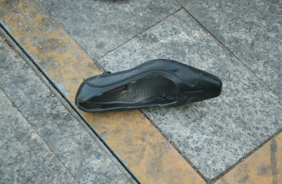 LONELY WOMAN SHOE ON THE STREET