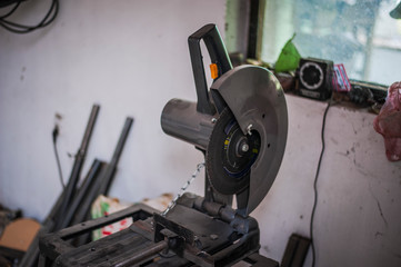 Cutting machine for metal in workshop. Grinder