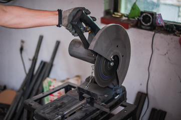 Cutting machine for metal in workshop. Grinder
