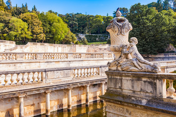 Fototapeta na wymiar A beautiful fountain in the Jardin de la fontaine in Nimes, France