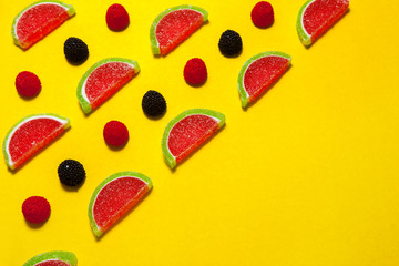 Fruit jelly segments in the form of watermelon on yellow