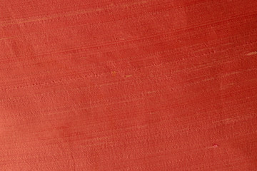 Close up of a woolen fabric of red orange color. Abstract canvas background, empty template.