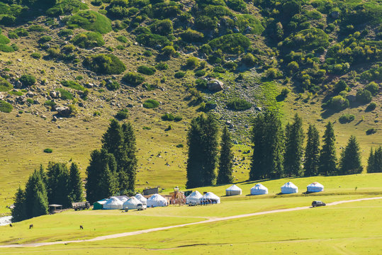 Kyrgyz Zhailau. White yurts stand at the foot of the mountain. Mountain gorge Jety Oguz. Nature in the area of lake Issyk-Kul.