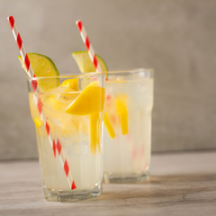 Cocktail with lemonade with lemon and lime, cold refreshing drink or drink with ice