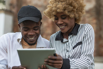 Obraz premium Young Black Happy Friends Watching Photos On Smartphone