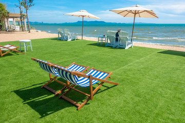 lounge chairs with sun umbrella on a beach