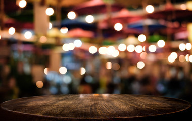 Selective Empty wooden table in front of abstract blurred festive light background with light spots...