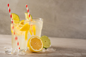 Lemonade. Drink with fresh lemons and limes. Summer mood, Lemon cocktail with juice and ice.