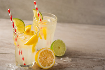 Lemonade. Drink with fresh lemons and limes. Summer mood, Lemon cocktail with juice and ice.
