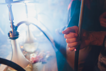 empty glass hookahs under the light of neon against the background of the restaurant. beautiful...