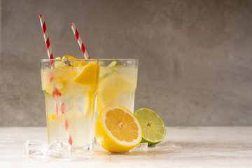 Lemonade. Drink with fresh lemons and limes. Summer mood, Lemon cocktail with juice and ice.
