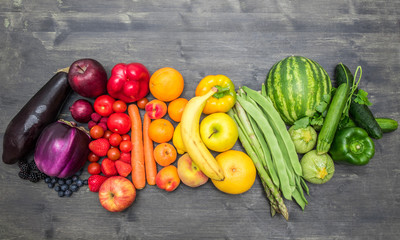 rainbow fruit and vegetables on wood