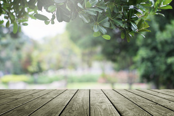 Wooden table and blurred green nature garden background.