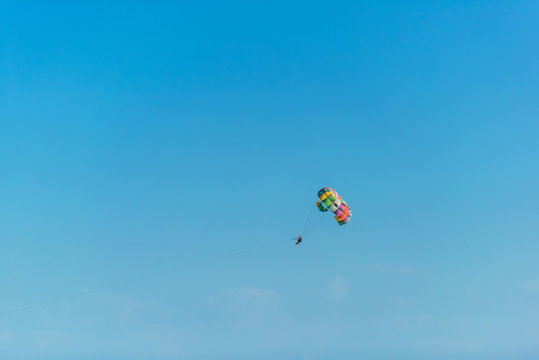 Flight on a parachute behind a boat on lake Issyk Kul. Extreme form of recreation. Rest in Kyrgyzstan.