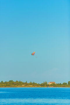Flight on a parachute behind a boat on lake Issyk Kul. Extreme form of recreation. Rest in Kyrgyzstan.