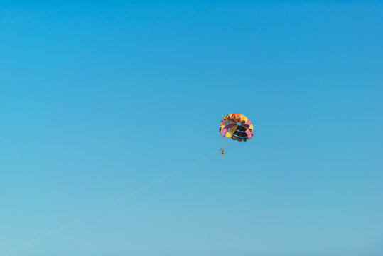 Flight on a parachute behind a boat on lake Issyk Kul. Extreme form of recreation. Rest in Kyrgyzstan.
