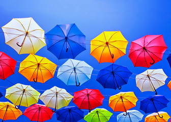 Fototapeta na wymiar Colorful umbrellas on the sky background.