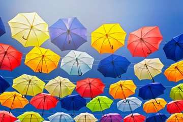 Fototapeta na wymiar Colorful umbrellas on the sky background.