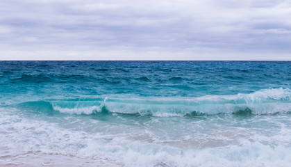 Cloudy and windy day over the Atlantic Ocean viewed from a beach in the Bahamas.