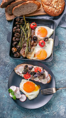 Fototapeta na wymiar Tasty breakfast. Eggs, sandwich, cheese, vegetables, mushrooms, bread and herbs. Top view