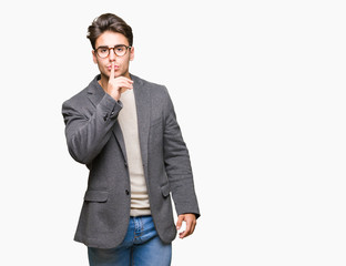 Young business man wearing glasses over isolated background asking to be quiet with finger on lips. Silence and secret concept.