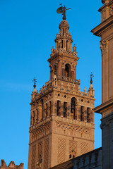Famous tower of Giralda, Islamic architecture built by the Almohads and crowned by a Renaissance bell tower with the statue of Giraldillo at its highest point, Seville Cathedral.