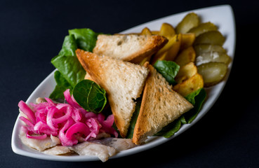 Snack  made from potatoes, herring and pickled vegetables