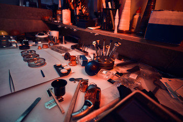 Watches master workshop. Workshop with tools, illuminated with warm light
