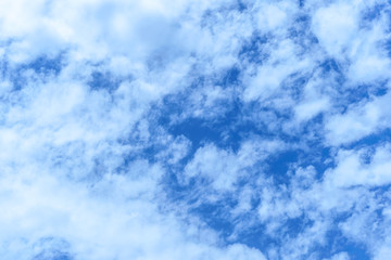 light fluffy clouds on a bright blue sky