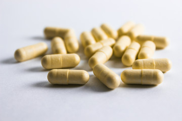 Pills on white background. Medical care and treatment. Medicine and pills, medications on white background. Yellow  drugs.