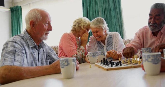 Active senior diverse people playing chess game in the nursing home 4k