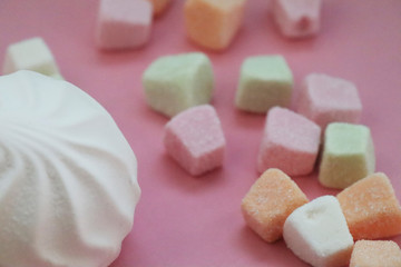 Colorful marshmallows on pink background