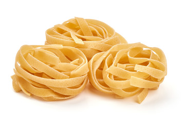 Raw tagliatelle pasta, Itallian food, close-up, isolated on white background