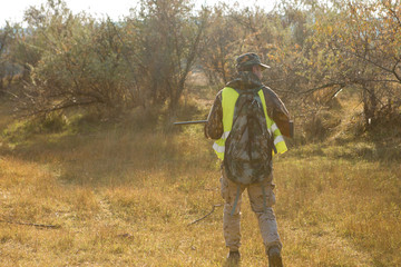 Hunters with a german drathaar and spaniel, pigeon hunting with dogs in reflective vests	