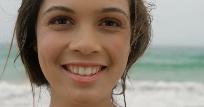 Front view of Caucasian woman standing on the beach 4k