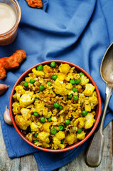 cauliflower green peas turmeric rice on a wood background
