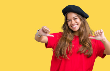 Young beautiful brunette fashion woman wearing red t-shirt and black beret over isolated background...