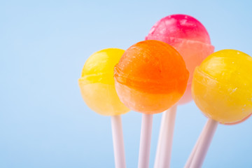 Bunch of lollipop candies on blue background