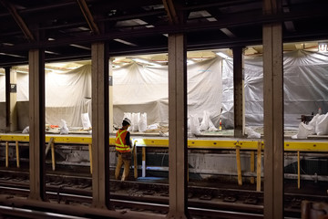 NEW YORK, USA - OCTOBER 22, 2018: Repair in New York subway. MTA worker repairing the platform of...