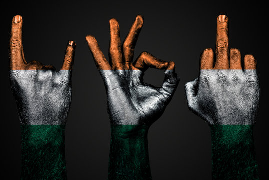 a set of three hands with a painted flag Ireland show middle finger, goat and Okay, a sign of aggression, protest and approval on a dark background.