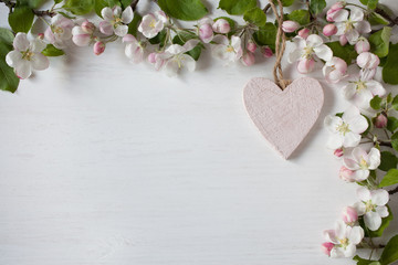 Spring background with blooming apple tree branches, heart, for congratulations, text
