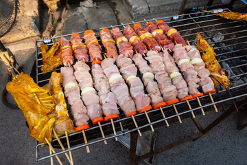 Grilled kebab cooking on metal skewer. Roasted meat cooked at barbecue. BBQ fresh beef meat chop slices.