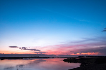 Fototapeta na wymiar Beautiful sunrise on the lake. Colorful sky.