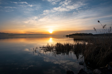 Fototapeta na wymiar Beautiful sunrise on the lake. Colorful sky.