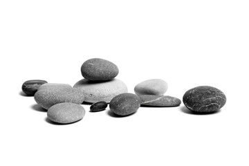 Sea pebbles. Heap of scattered and stacked smooth gray and black stones isolated on white background