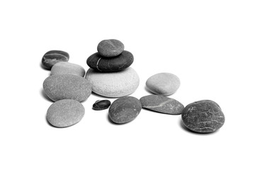 Sea pebbles. Heap of scattered and stacked smooth gray and black stones isolated on white background
